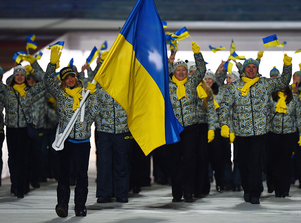 SOCHI, RUSSIA - FEBRUARY 07: Cross country skier Valentina Shevchenko of the Ukraine Olympic team carries her country's flag during the Opening Ceremony of the Sochi 2014 Winter Olympics at Fisht Olympic Stadium on February 7, 2014 in Sochi, Russia. (Photo by Pascal Le Segretain/Getty Images)